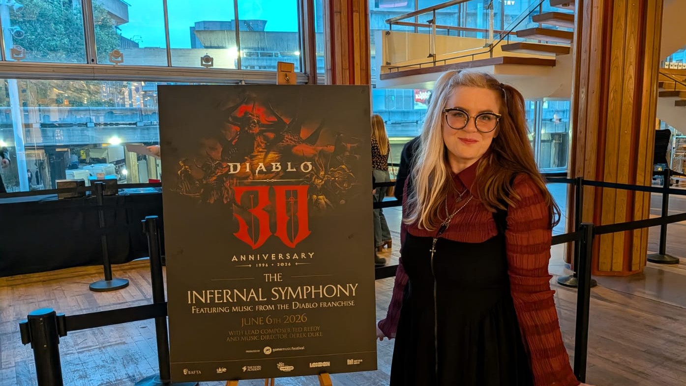 Woman standing next to sign that says "Diablo 30th Anniversary, Infernal Symphony"