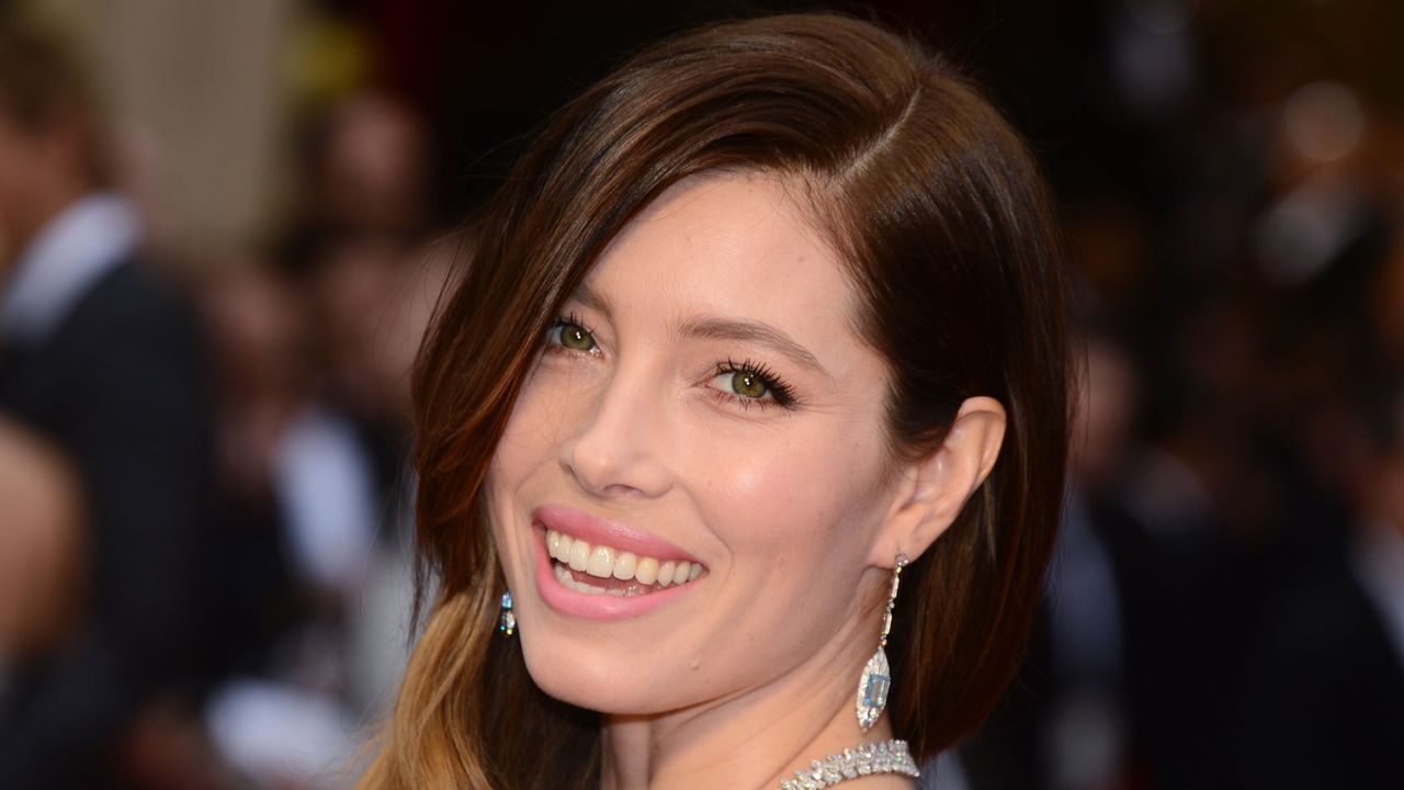 Smiling Jessica Biel wearing a diamond necklace and earrings