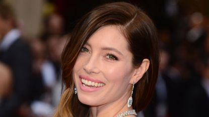 Smiling Jessica Biel wearing a diamond necklace and earrings