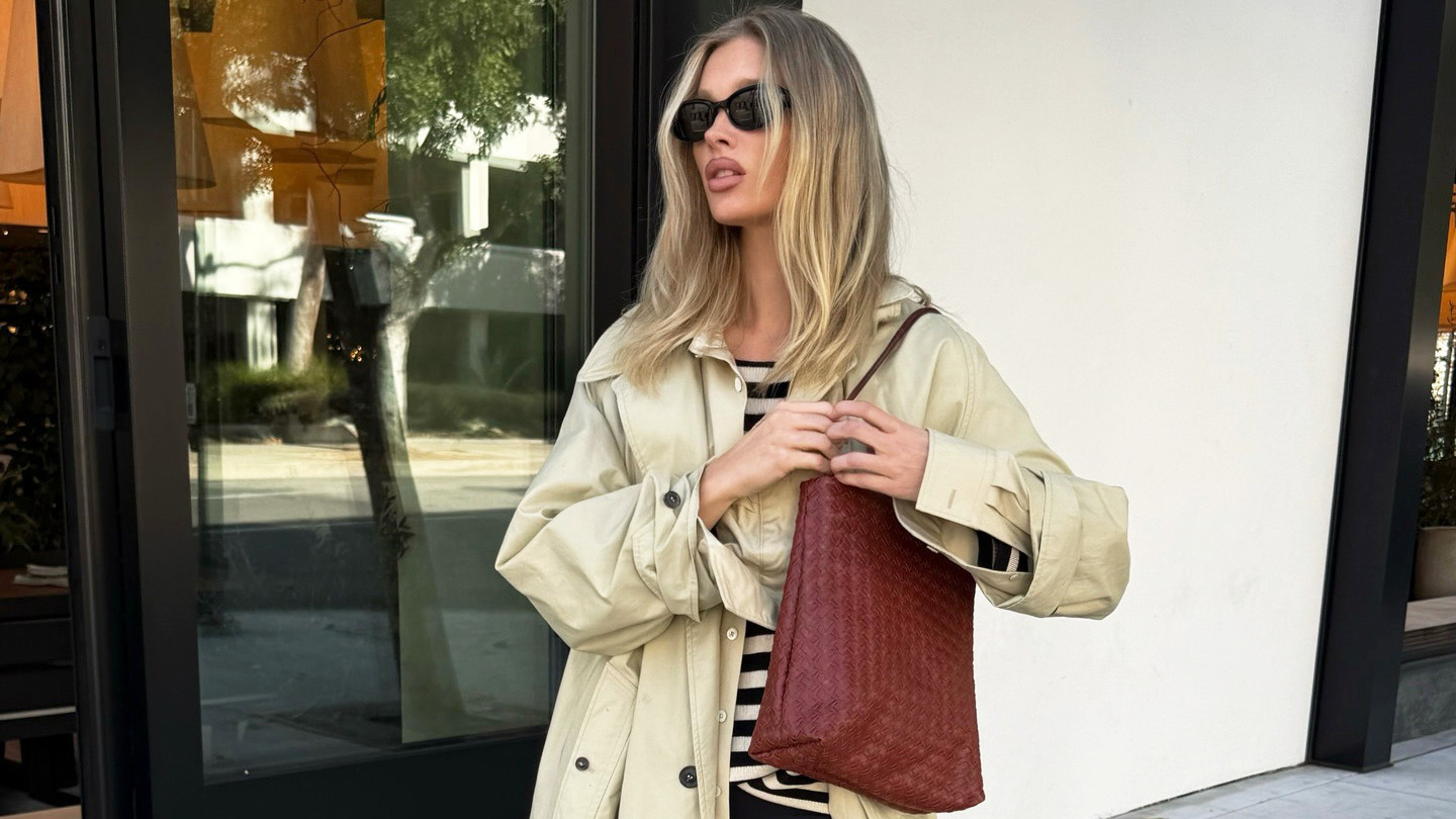 Elsa Hosk wearing a trench coat, striped shirt, cropped flare pants, and kitten-heel slingback shoes