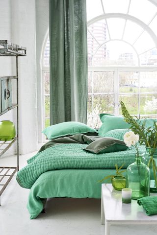 Designers Guild bedroom with green bedding