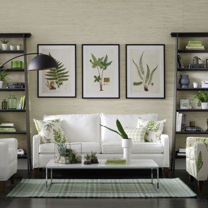 white and green living room with three prints on wall