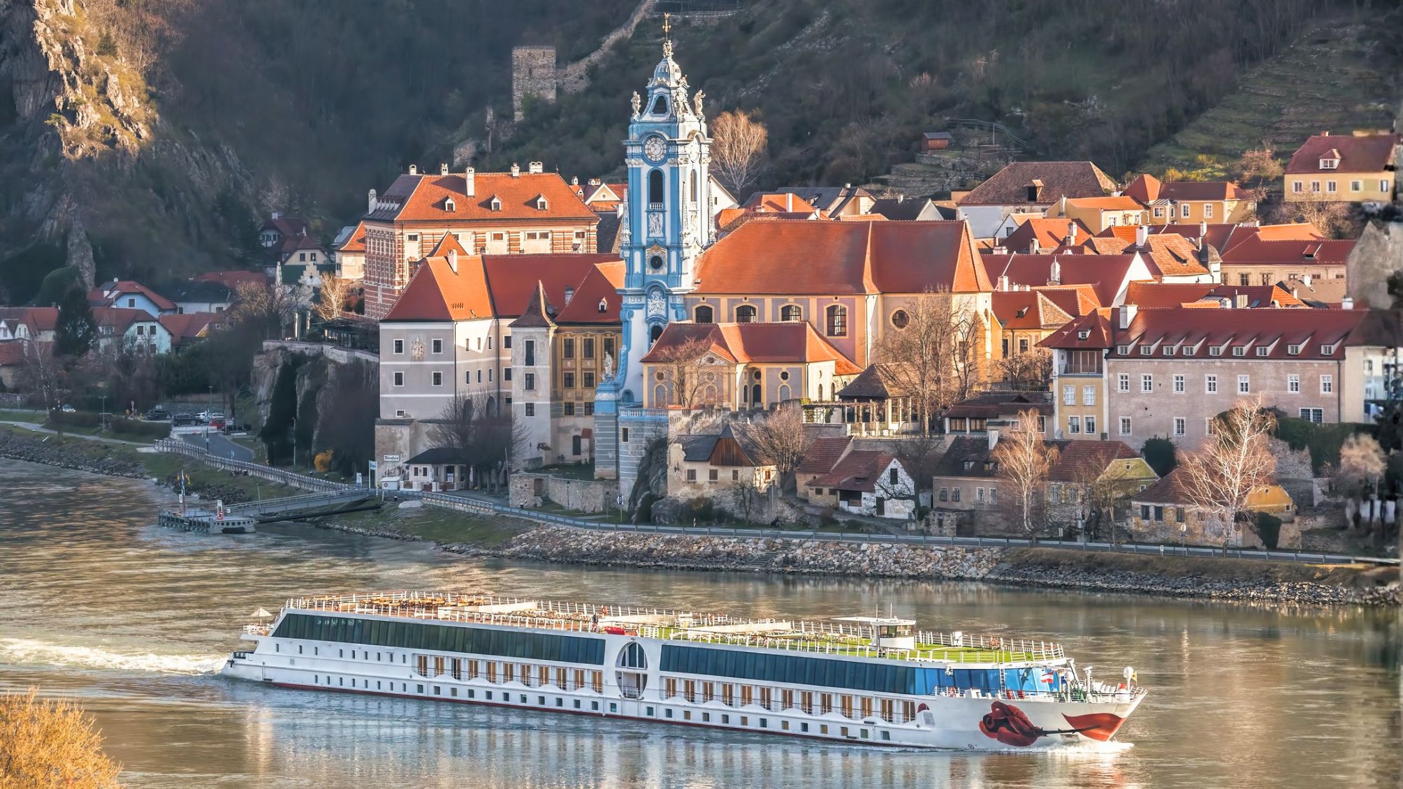 Durnstein village during spring time with tourist ship on Danube river in Wachau (UNESCO), Austria