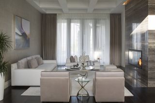 A living room with grey wall coverings, neutral furniture and a contemporary marble fireplace