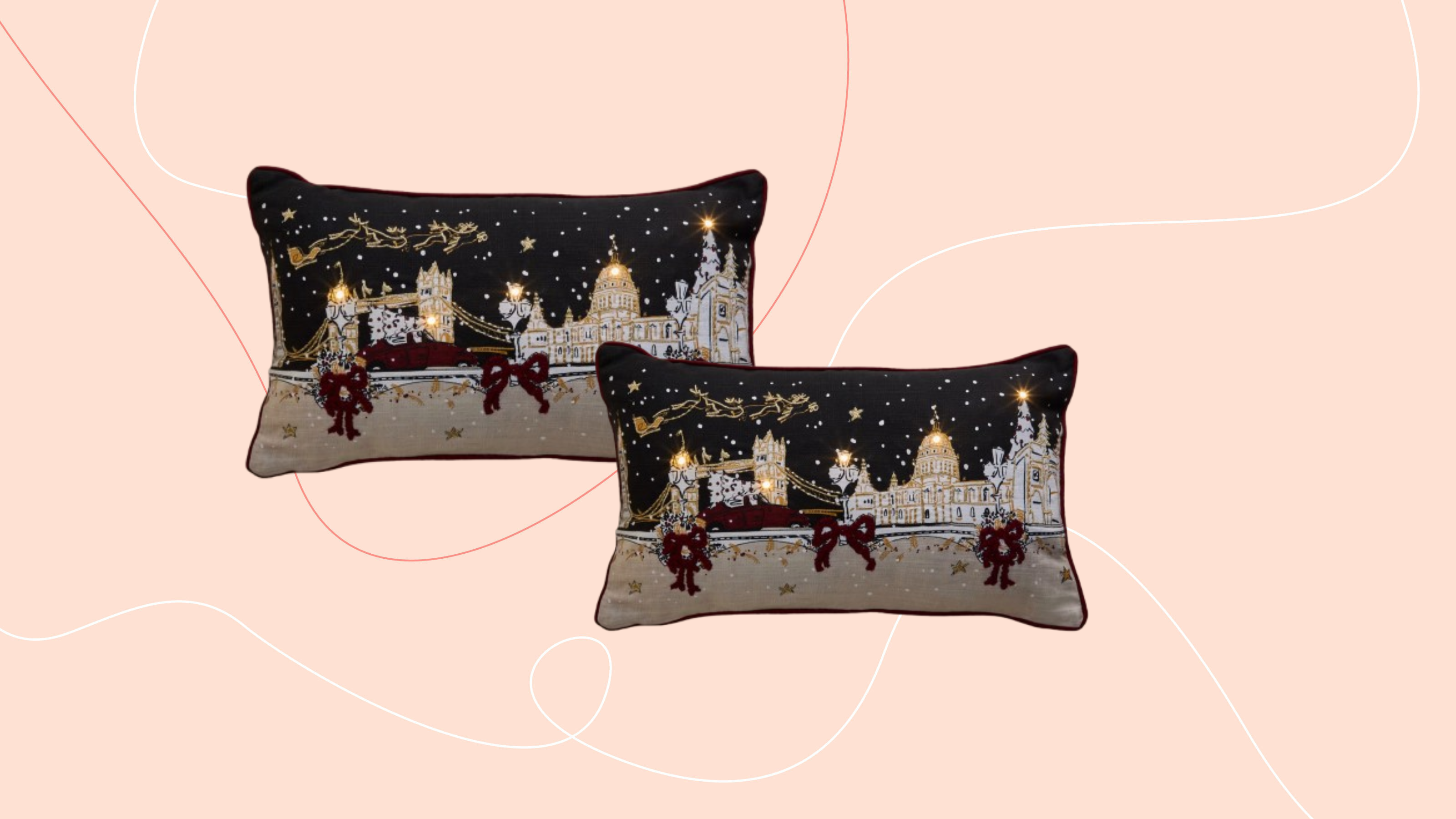 M&amp;S Light Up Townhouse Bolster Cushion on pink background.