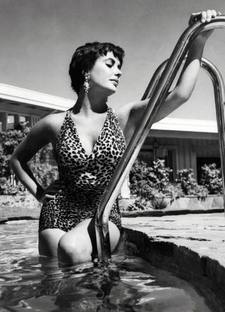 British-born American actress Elizabeth Taylor in a swimming pool