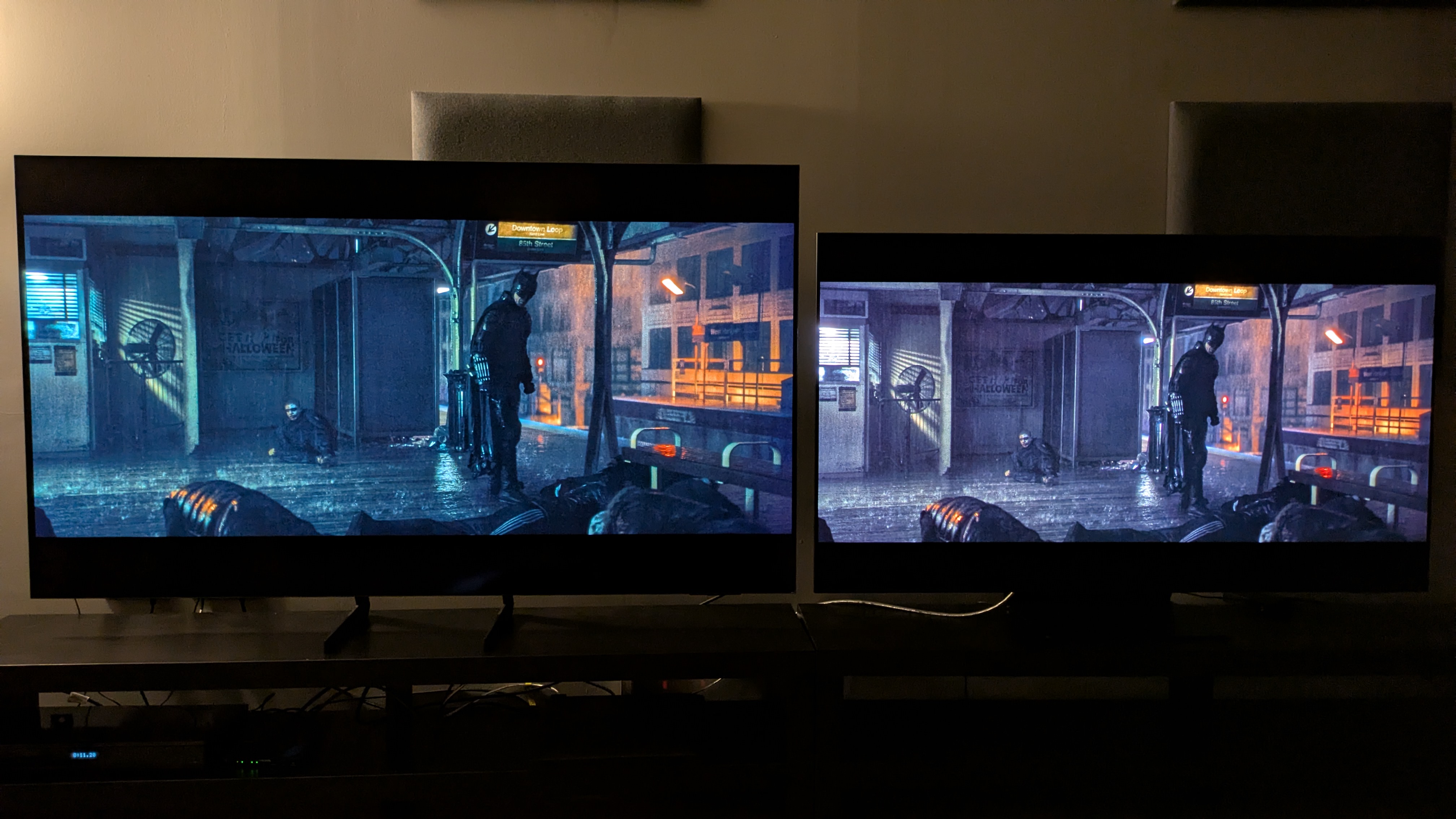 Samsung S85F (left) vs Samsung S95F (right) showing the subway fight scene from The Batman with both TVs in dimmed conditions