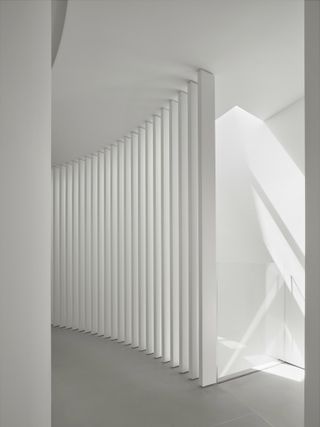 Bespoke minimalist white corridor at Round House by Feldman architecture
