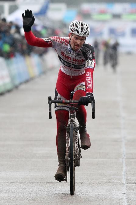 Jim Aernouts crosses the finish line in third place