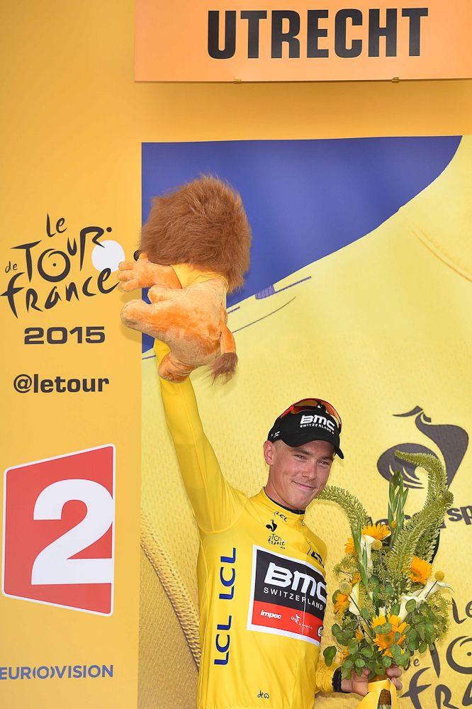 Rohan Dennis celebrates on the stage 1 podium.