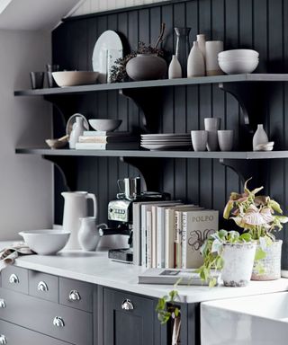 black kitchen with open shelving and plenty of drawers