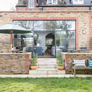 bricked house exterior with garden lawn