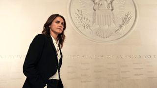 Kate Wyler (Keri Russell) standing in front of a US Crest in Netflix's "The Diplomat" season 1