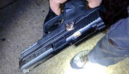 A bullet lodged in the side of a police officer’s gun following a shooting in Chicago