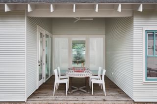 A back porch with a dining