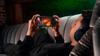 Razer Kishi V2 Pro lifestyle image featuring a man playing Minecraft Dungeons via Xbox Game Pass