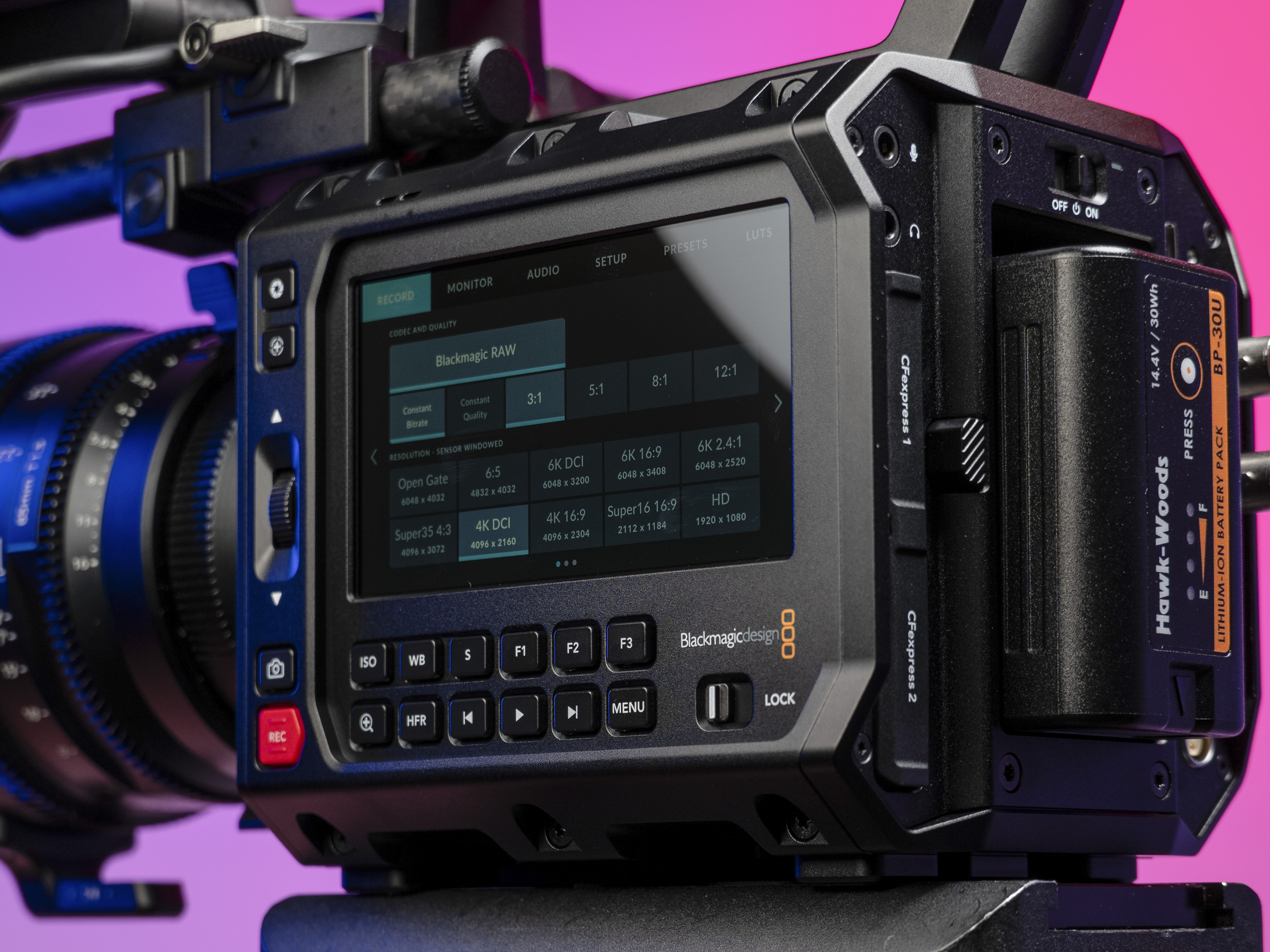 Closeup of the Blackmagic Pyxis 6K camera's controls, in the studio with a vibrant magenta background