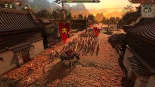 An army of Khorne marching through a street in Total War: Warhammer 3
