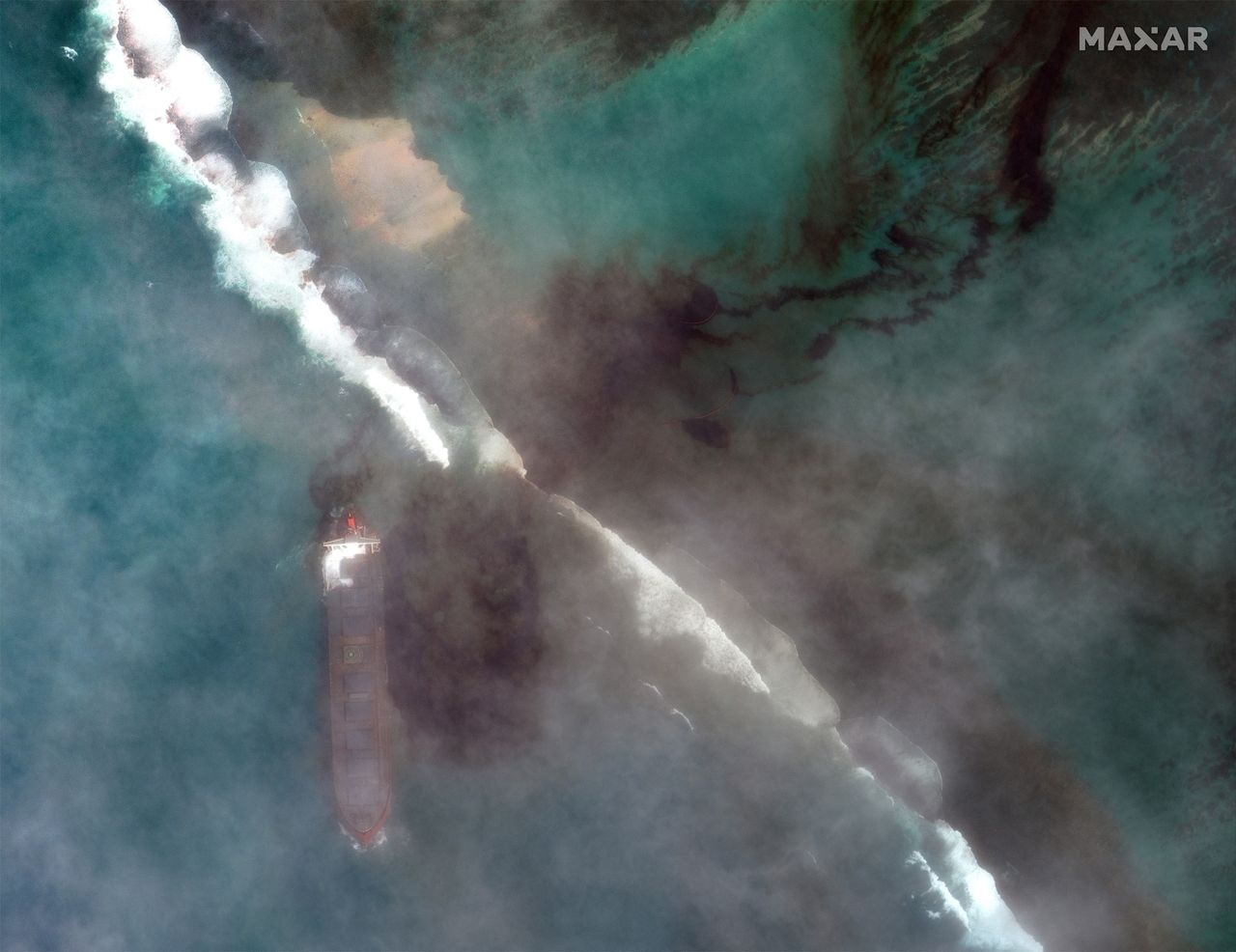 A bulk carrier ship, MV Wakashio, that recently ran aground off the southeast coast of Mauritius has been spilling oil into the sea, as seen in satellite images captured by Maxar Technologies on Aug. 7, 2020.