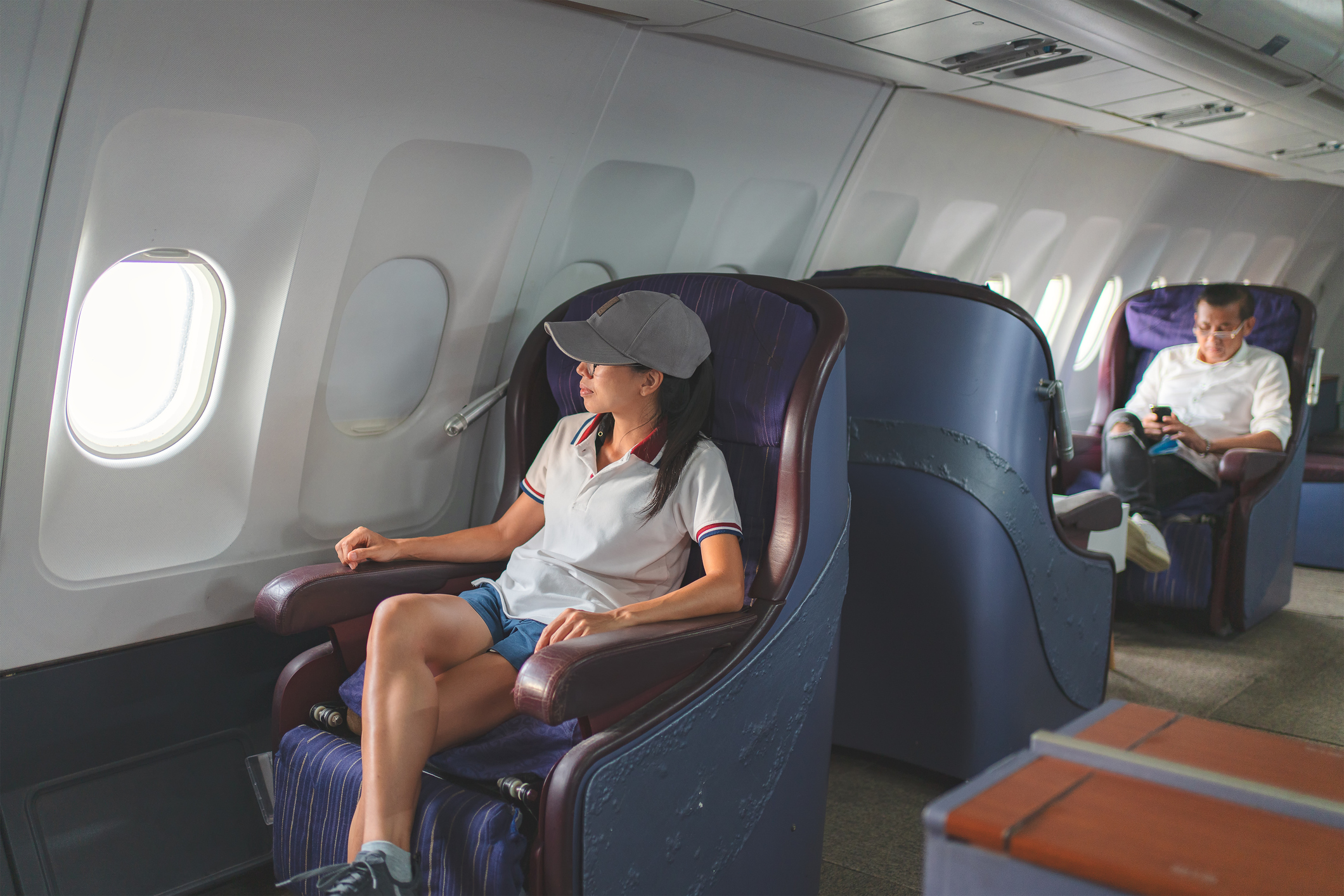 A passenger seated in first class on a Delta flight.