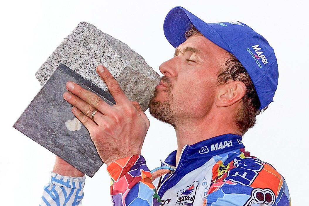 Johan Museeuw kisses the cobblestone trophy after winning the 2000 Paris-Roubaix