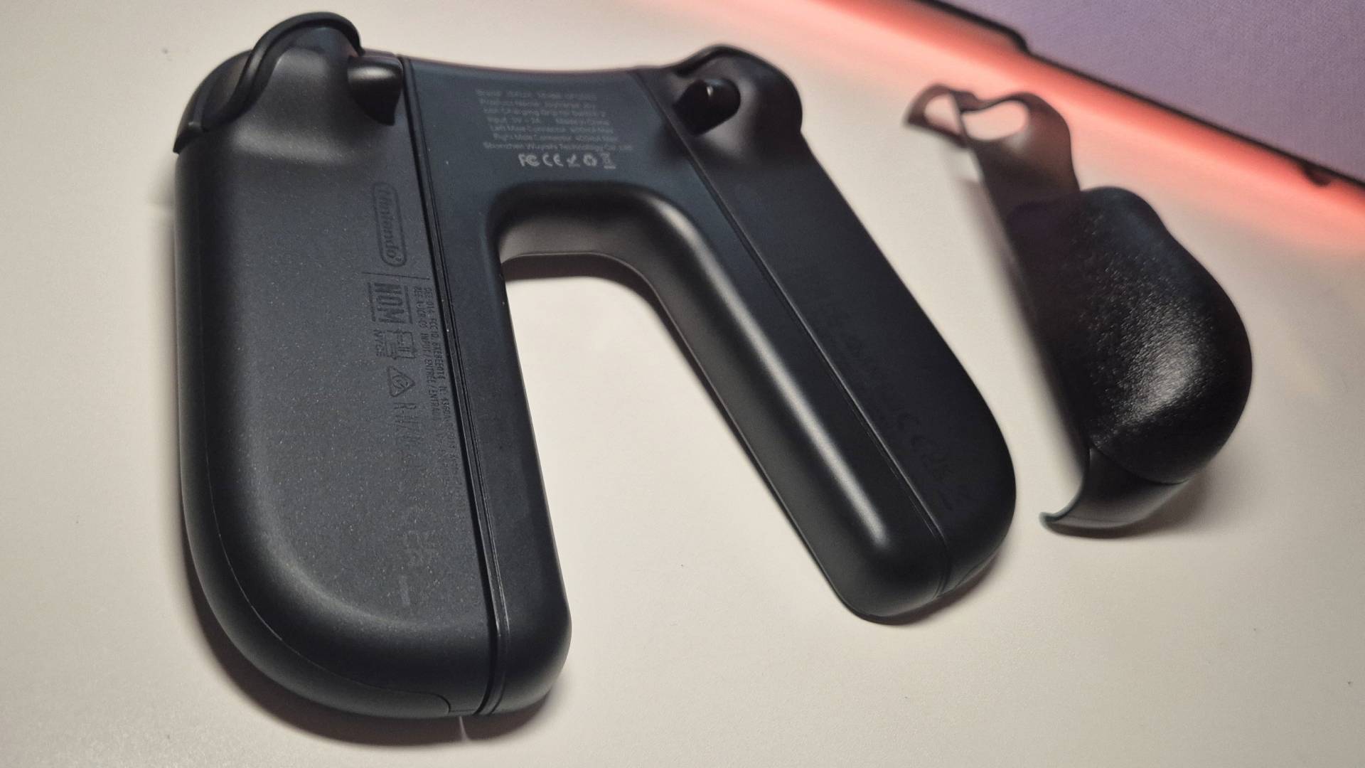 Photo of the back of the Joy-Cons attached to the JSAUX Switch 2 Charging Grip.