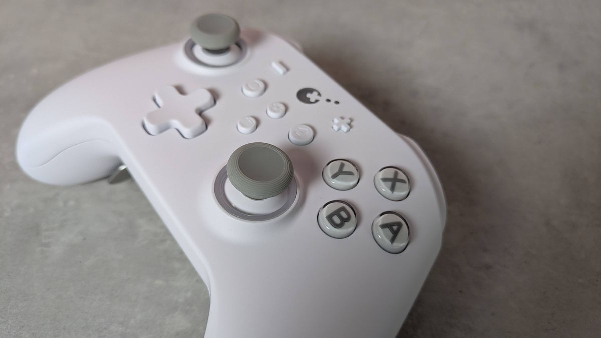 Close-up of right analog stick on GuliKit KK3 Max, on a grey desk