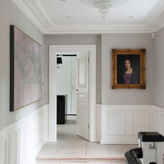 landing area with white white wall frame on wall and white door