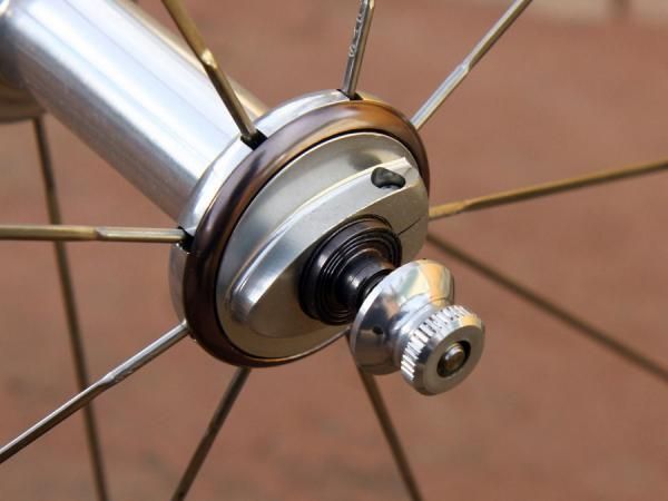 Hub bearing preload is easily adjusted with these threaded collars. Up front, there's a matching collar on the opposite side that doesn't adjust bearing preload but is still rotatable so that both sides are matched.