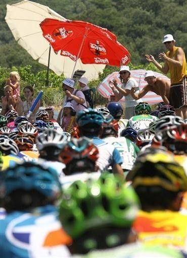 Crowds watch the Tour on a hot Sunday