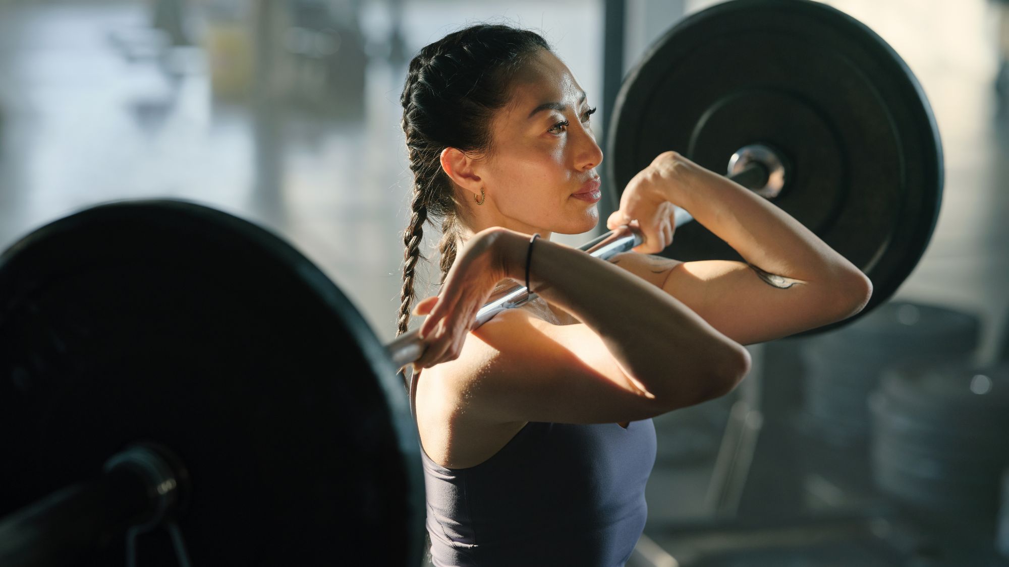 A woman lifting weights in the gym