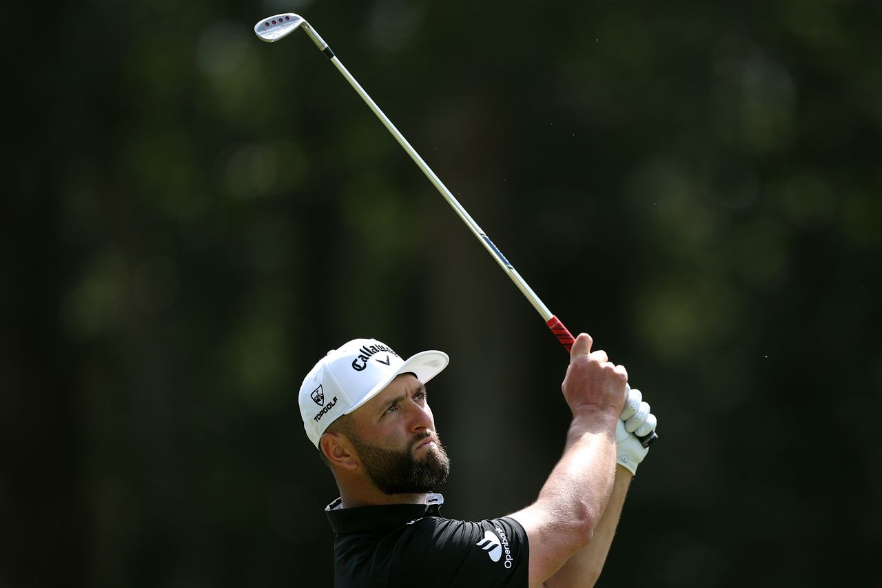 Jon Rahm watches his wedge shot