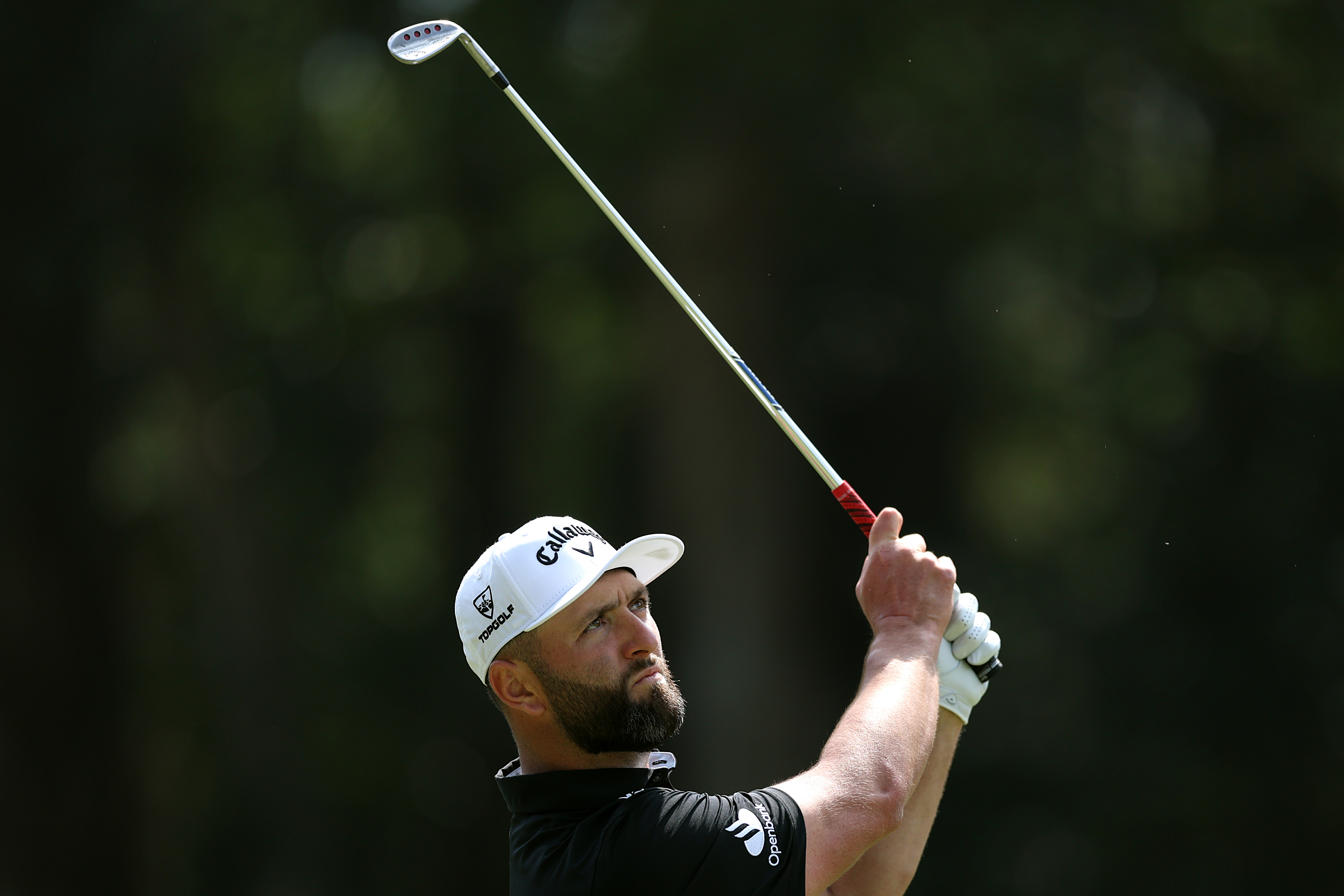 Jon Rahm watches his wedge shot