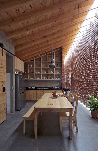 interior dining area of brick house by Natura Futura