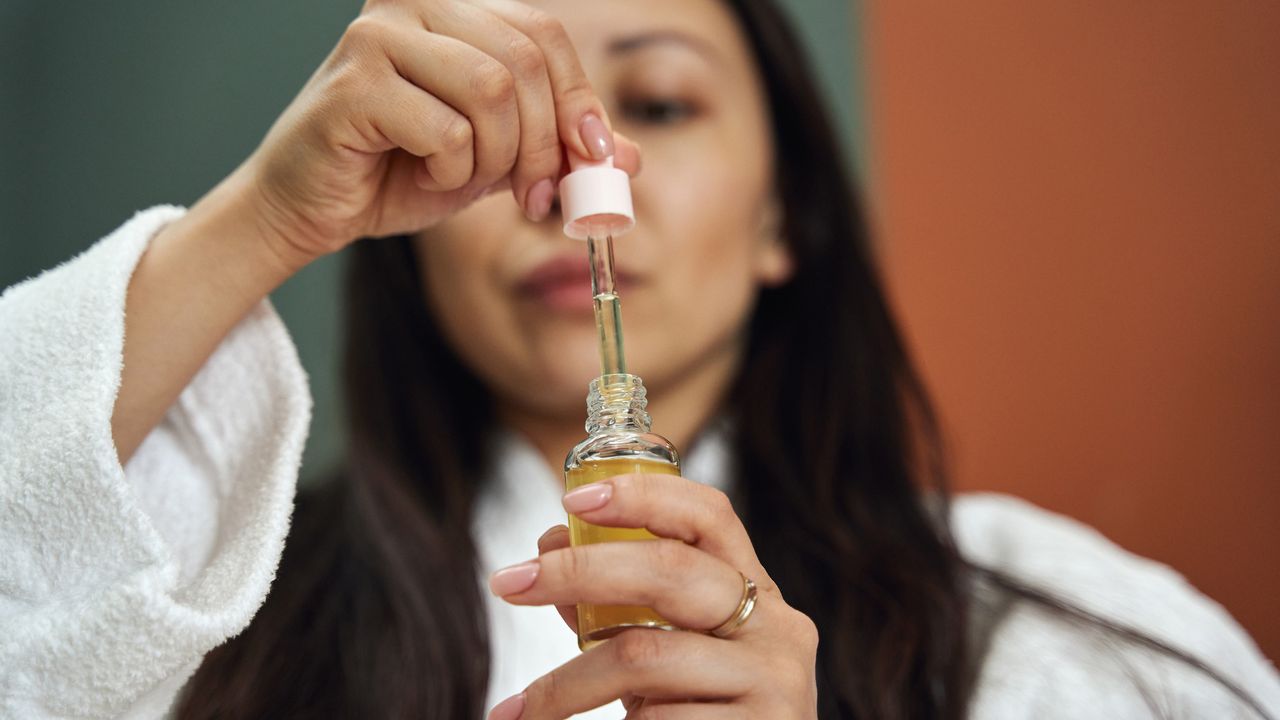 Woman uses Vitamin C serum