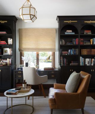 Home office with dark painted bookshelves
