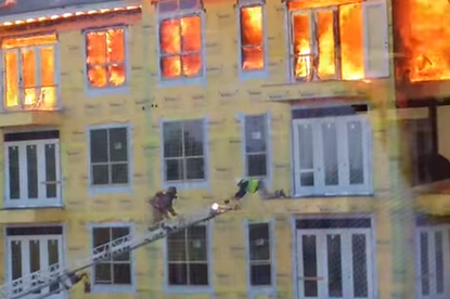 Incredible video shows a worker's dangerous rescue from a burning Houston building