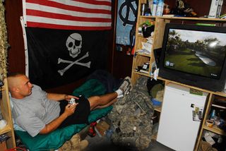 Sgt. Daniel Tripp, of Chapel Hill, N.C.(left), and Sgt. Dustin Butcher, of Wilson, N.C., unwind between missions by testing each other's golfing abilities on an Xbox game as Sgt. Joseph Jones, of Boomer, N.C. waits for his turn in the competition June 30. The three are infantrymen with Company B, 252nd Combined Arms Battalion, 30th Heavy Brigade Combat Team and live together at Joint Security Station Saydiyah, in southern Baghdad.