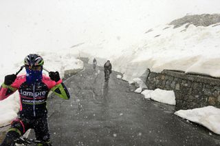 A cyclist stops to get warm on stage sixteen of the 2014 Giro d'Italia