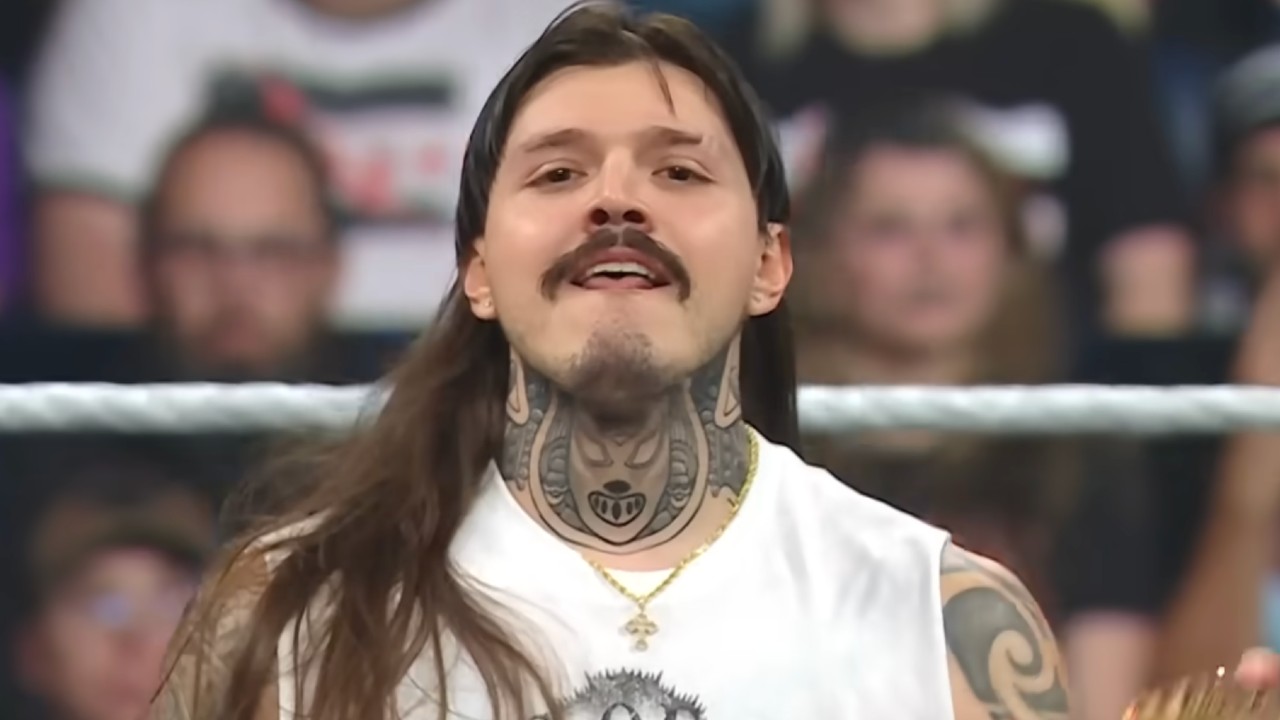 Dirty Dom smirking at the camera after kicking a wrestler. 