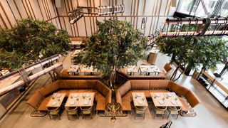 The interior of Eos & Nyx, decorated in plants and fresh looks. elevating dining experiences with d&b audiotechnik. 