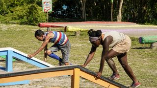 Romeo Escobar and Maryanne Oketch run through an obstacle course on Survivor