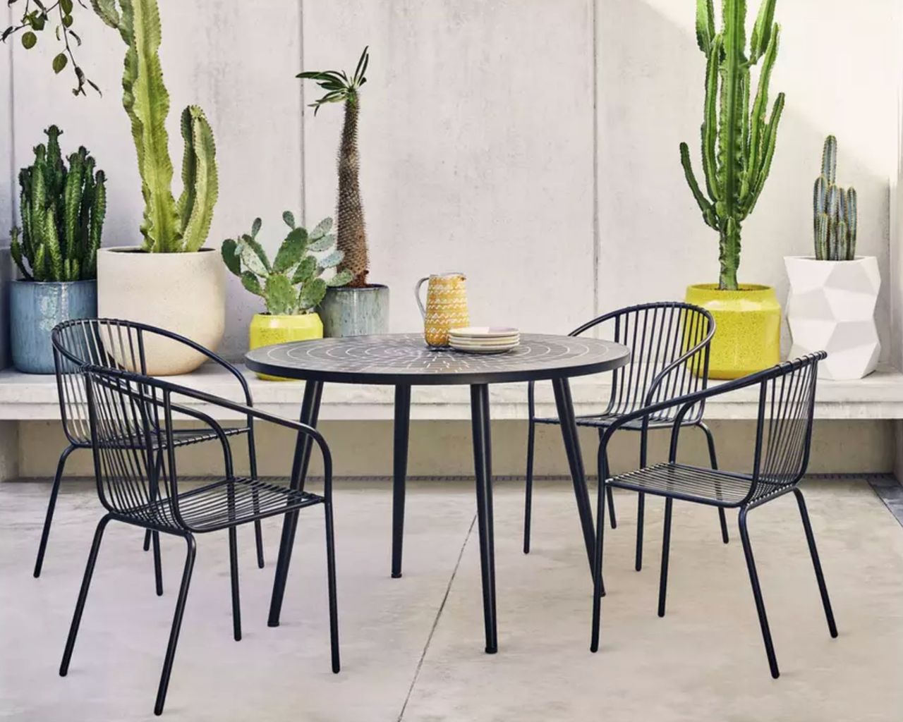 Habitat garden furniture set, 4 seater metal set on a terrace surrounded by plants