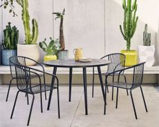 Habitat garden furniture set, 4 seater metal set on a terrace surrounded by plants