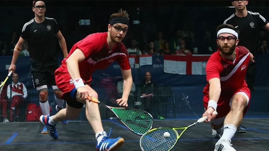 Four men playing Squash