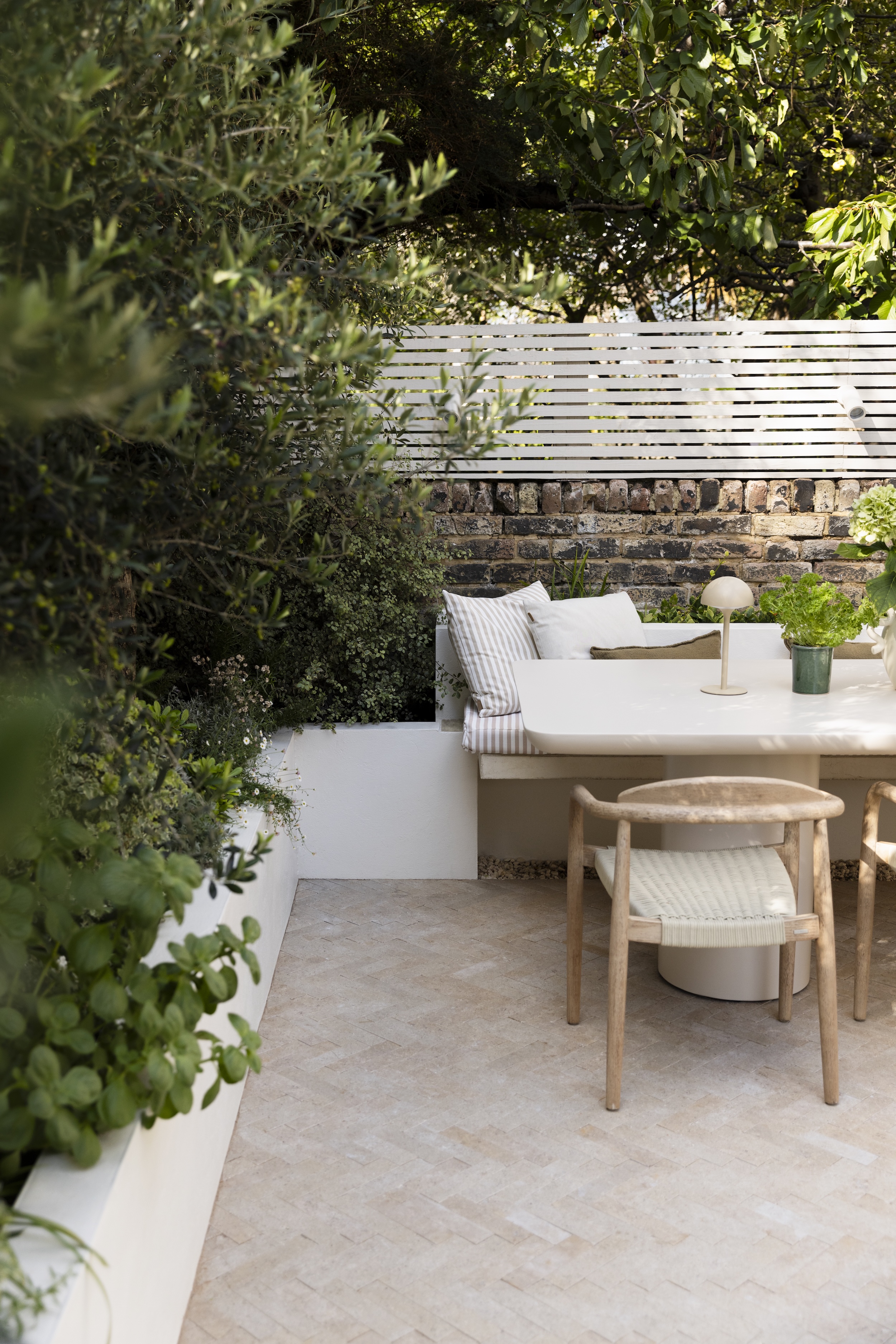 a mediterranean garden in london with built-in seating area