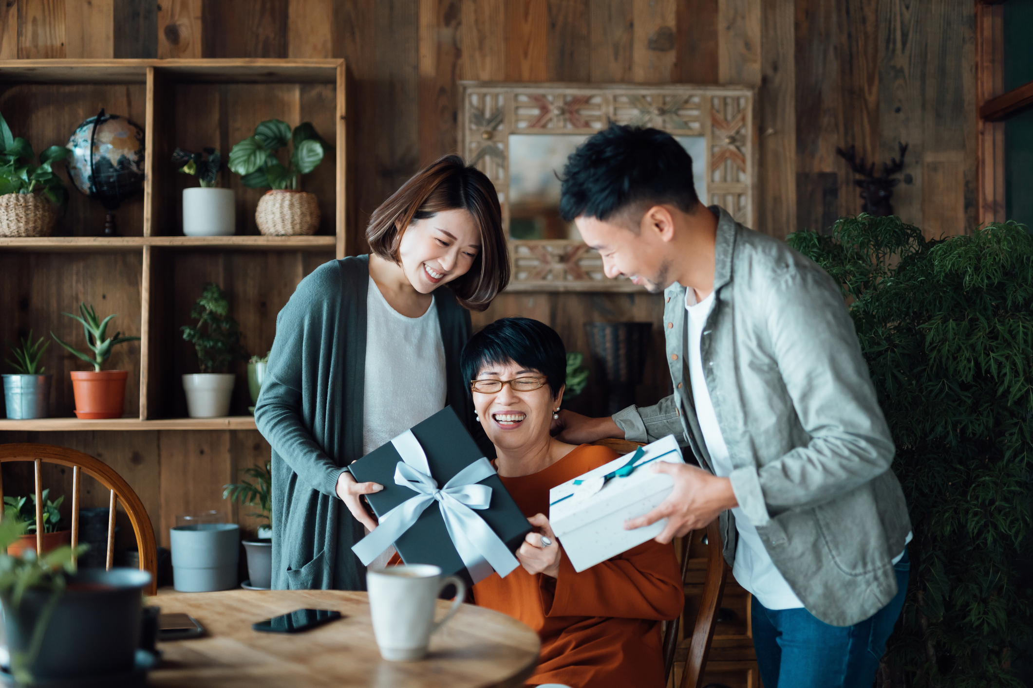 A mother receives gifts from her son and daughter.