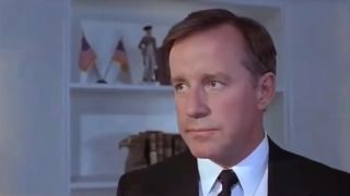 Phil Hartman stands with a stoic expression in The Second Civil War.