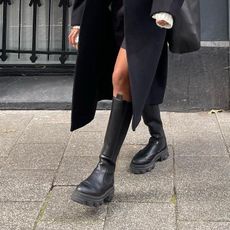 A woman wearing chelsea boots 