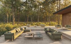 Vondom Pasadena outdoor furniture collection on a paved terrace amid forest